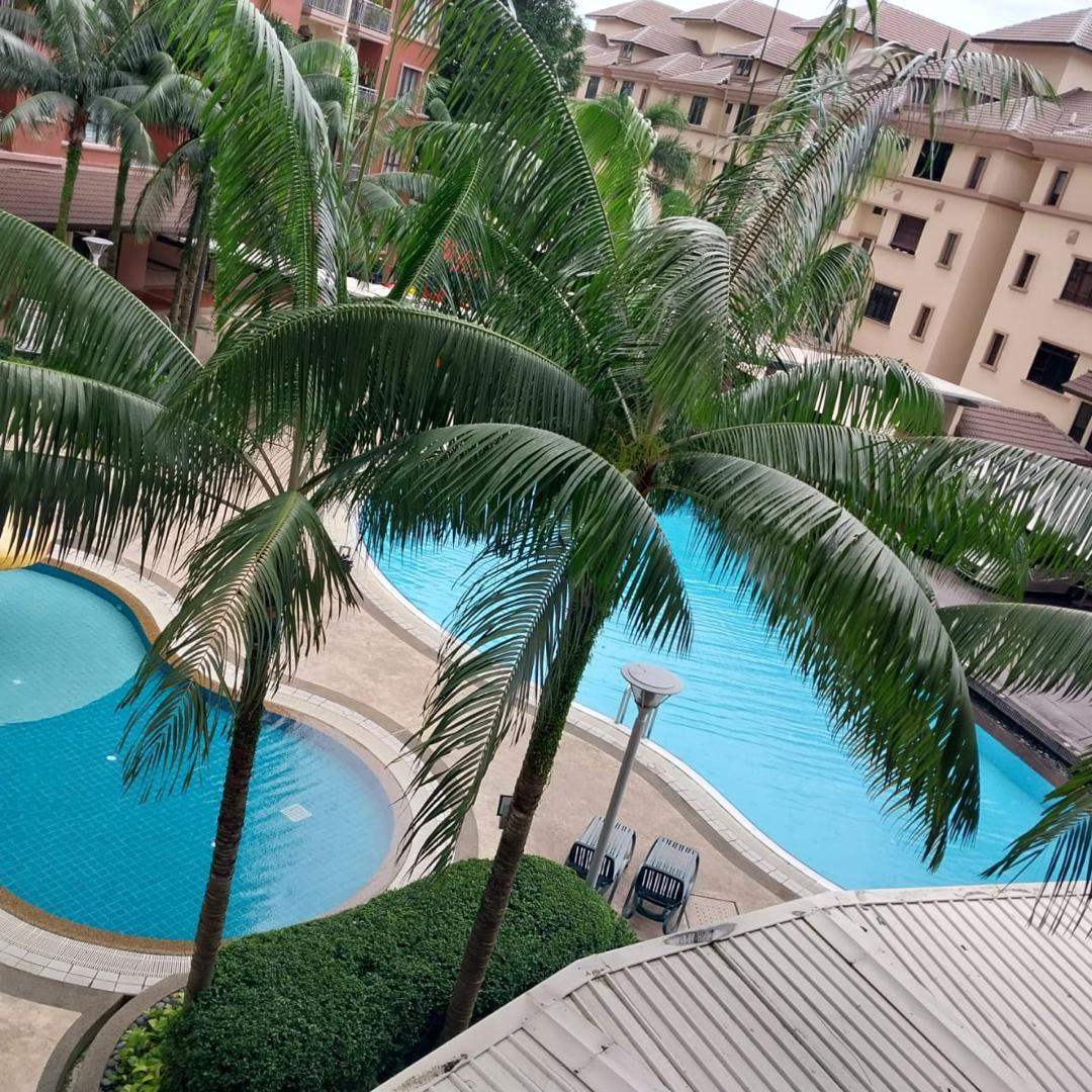 Swimming pool and landscaped greenery viewed from a Casa Indah 1 condominium balcony