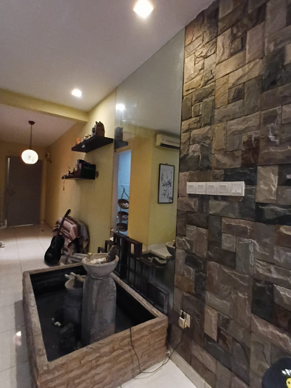 Stone wall decor and water feature detail in the Casa Indah 1 living area