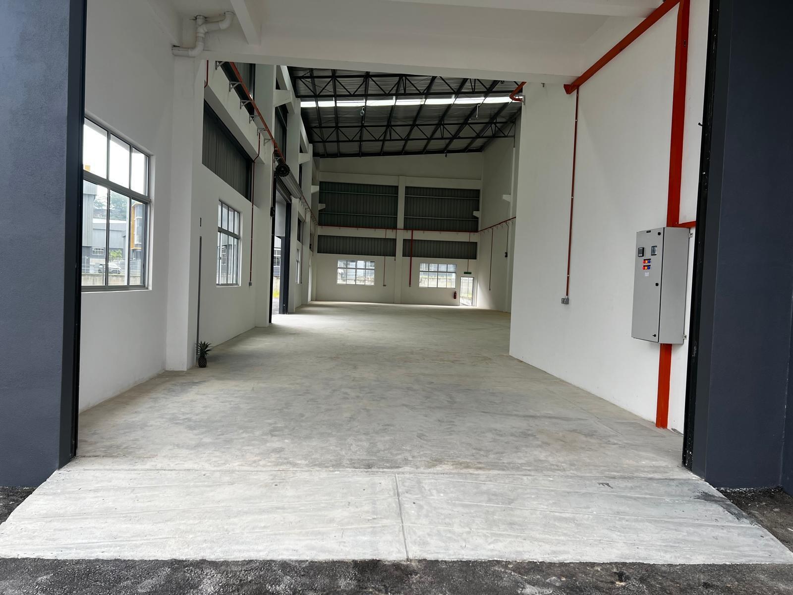 Wide interior view of the vacant factory floor at XME Business Park, Nilai